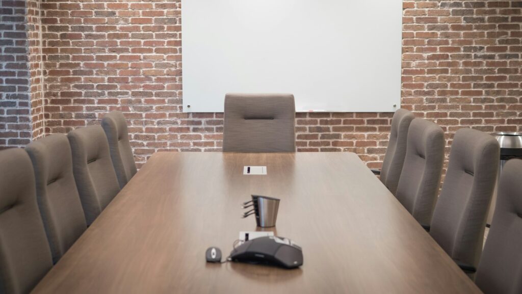 Conference room with a projector screen and chairs, set up for a meeting presentation